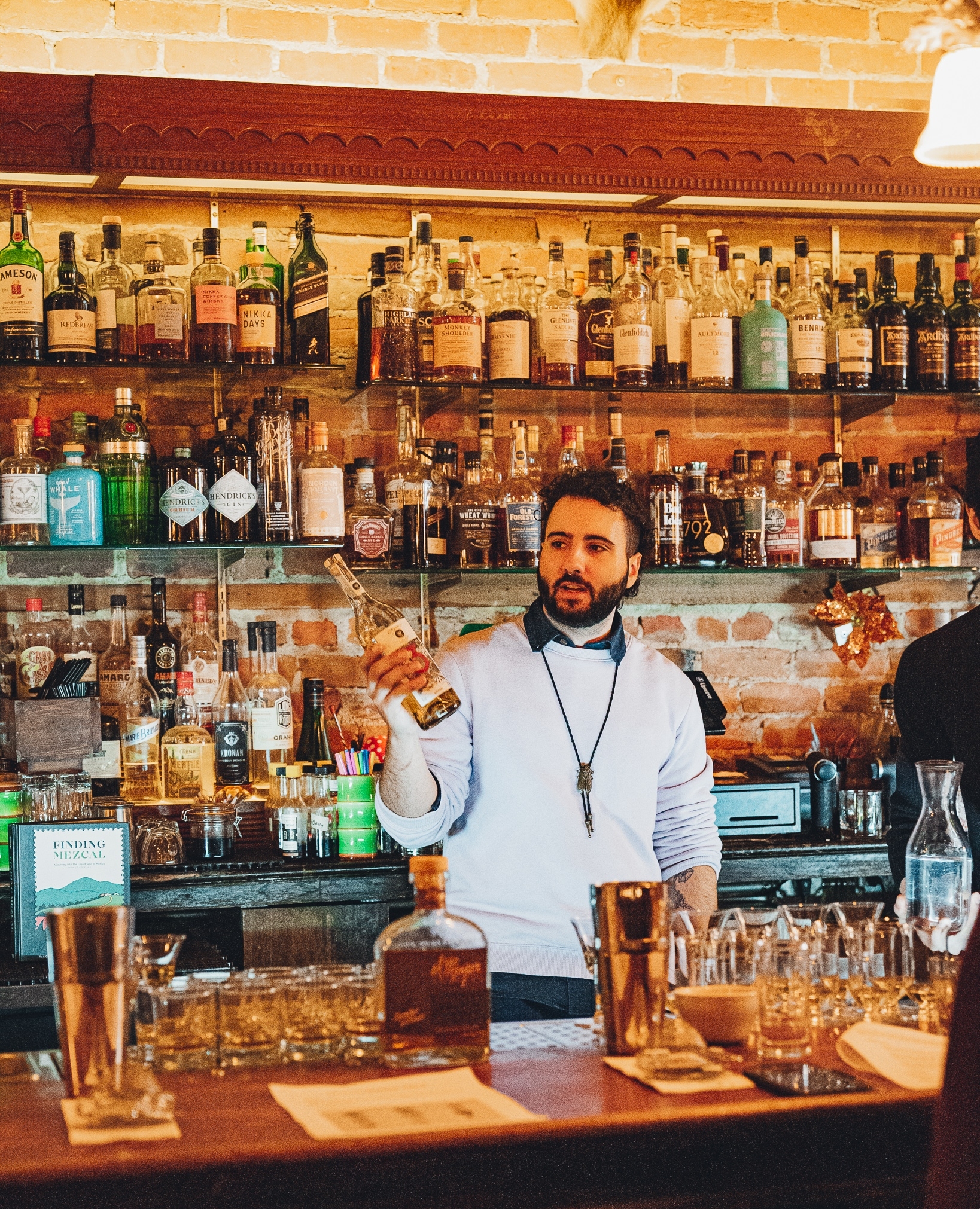 Sugar House bartender demonstrating cocktail techniques during a mixology class
